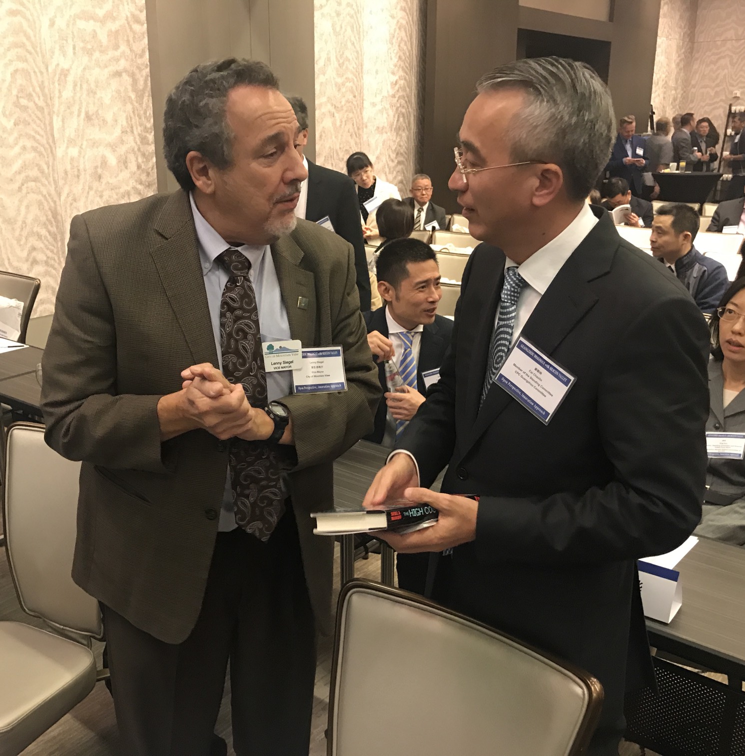 Lenny gives Cai Chaolin, head of the Guangzhou delegation, a copy of his 1985 book, “The High Cost of High Tech," co-authored by John Markoff.